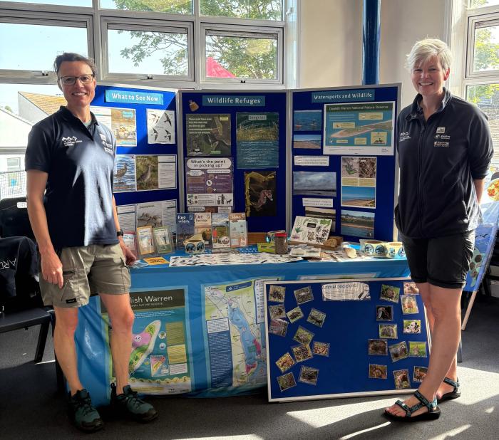 Marije and Katie with the display board at an event